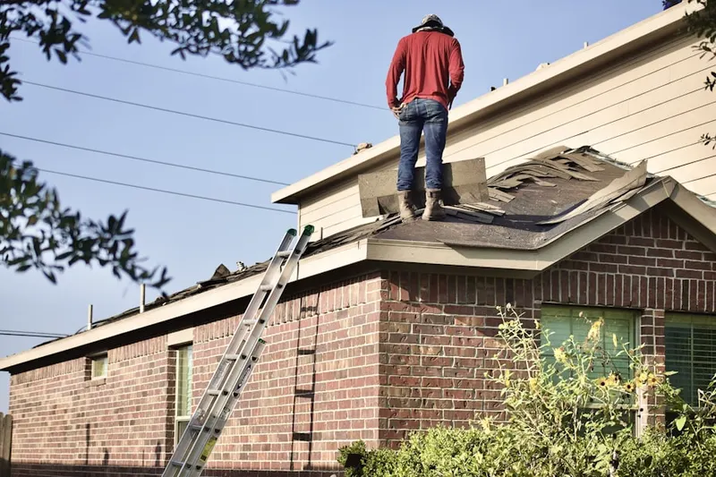 Professional roofer working on a residential roof in Naugatuck